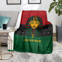 Personalized pharaoh blanket on a floor with red-black-green pattern and portrait artwork