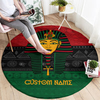Round pharaoh area rug with red-green-black design and 'Custom Names' text