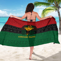 Black, red, and green pharaoh print sarong with geometric bands and custom name across center