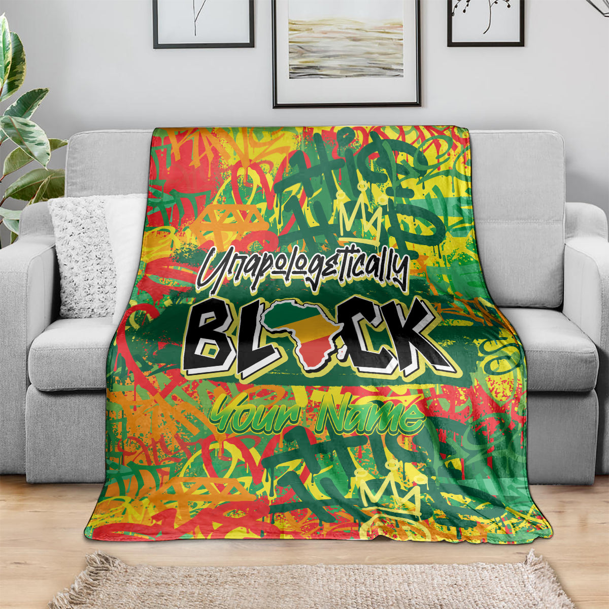 Personalized throw blanket draped on a sofa, green with red-orange graphics and black BLK text.