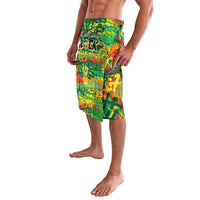 Green knee-length lavalava wrap skirt with vibrant multicolor graffiti print, side view