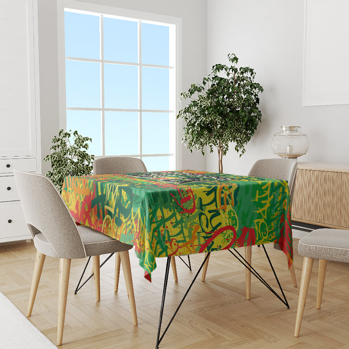 Green colorful tablecloth with graffiti pattern on dining table and beige chairs