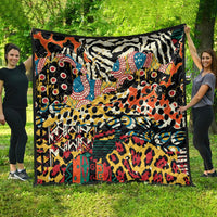 Africa animal-pattern quilt held outdoors, bold multicolor animal silhouettes on black
