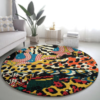 Round area rug with bright animal-print and geometric blocks in black, teal, red, yellow