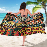 Multicolor animal-print sarong draped wide, leopard spots and geometric accents.