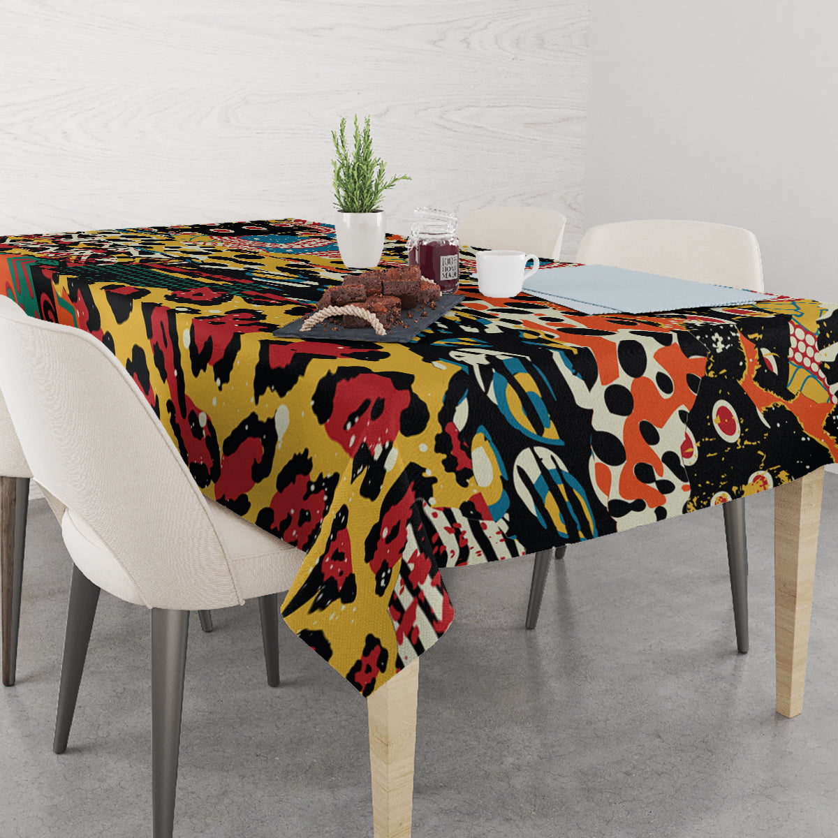 Multicolor animal-pattern tablecloth covering a dining table, with corners hanging