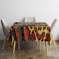 Square multicolor animal-pattern tablecloth on a dining table with draped corners