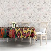 Bold multicolor animal-pattern tablecloth covering a table, edges neatly draped