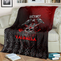 Viking blanket on couch, black-red design with ravens, skull emblem, and 'Victory'.