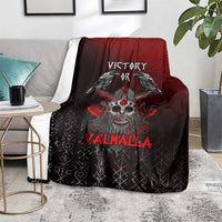 Viking blanket on gray sofa, black and red ravens-skull design with 'Valhalla' lettering.