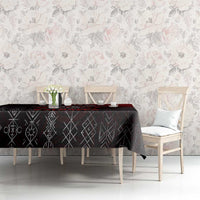 Black tablecloth with rune motifs and red accents, styled on dining table with chairs