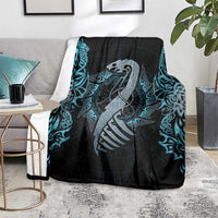 Dragon motif throw blanket on floor, black with blue teal rune and rope pattern