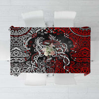 Red and black Viking knot and dragon motif tablecloth on a dining table.