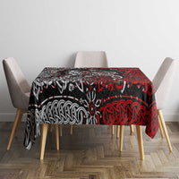 Red and black Viking knot and dragon motif tablecloth centered on dining table.