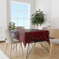Red and black Viking knot motif tablecloth on dining table with chairs.