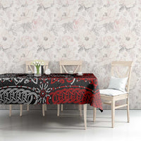 Red and black Viking knot and dragon motif tablecloth on a dining bench.