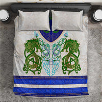 Bedding set with two white pillow shams and duvet with green dragon and blue trim