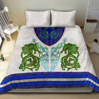 Bedding set with white pillow shams and duvet featuring green and blue dragon knot design