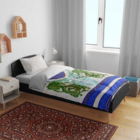 Bedding set on bed: white duvet with green dragon knot motif and blue border stripes