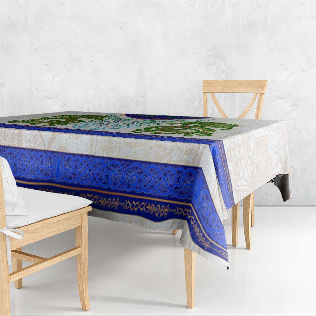 Dragon Celtic knot tablecloth draped over rectangular table, blue and green design