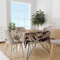 Bold patterned tablecloth with buffalo motif, tribal shapes, and multicolor feather accents
