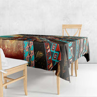 Printed tablecloth on table with hanging corner, black base and teal, red, and tan tribal motifs