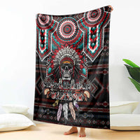 Red and black blanket with warrior skull graphic, teal medallions, and geometric trim