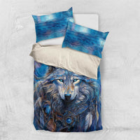 Blue wolf bedding set with duvet cover and two pillow shams on white sheets