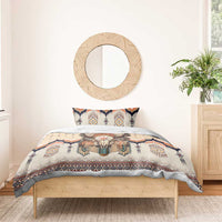 Beige duvet with feathered skull print and matching pillow, navy and orange tribal border