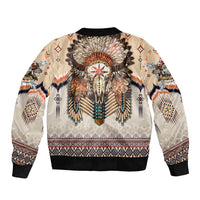 Beige bomber jacket with black ribbed trim and large central feathered headdress graphic