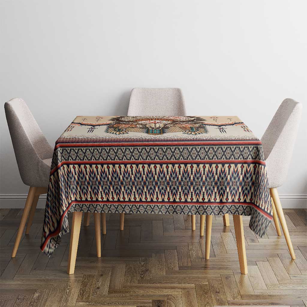 Beige tablecloth with multicolor geometric stripe border on a dining table.