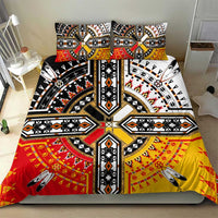Tribal bedding set with black, white, red, and yellow patterned duvet and pillow covers.