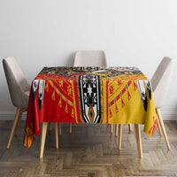 Native American tablecloth with red border and yellow field; black-and-white aztec-style motifs