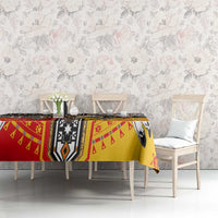 Native American tablecloth on table with red, yellow, black, and white stripe-and-motif pattern