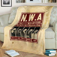 Beige group blanket with N.W.A burgundy poster graphic and six male portraits, partially draped
