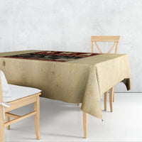 Beige tablecloth draped over square table with folded corner drop.