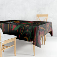 Black tablecloth with colorful abstract print, corner drop visible