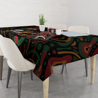 Black tablecloth with colorful abstract pattern on a dining table setting