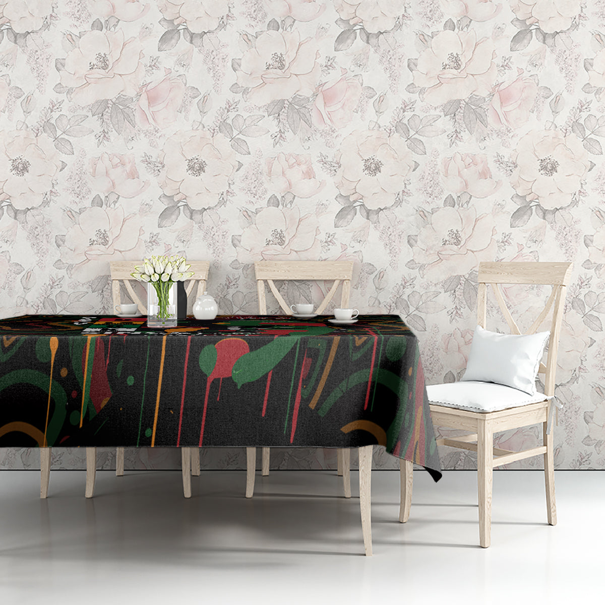 Black tablecloth with colorful abstract print covering a dining table