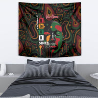 Personalized tapestry on plain wall, face portrait graphic with vertical letters and “Since 2024”