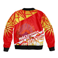 Red bomber jacket with Macedonia graphic on back, gold geometric pattern; black ribbed cuffs.