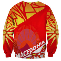 Red crewneck sweatshirt with circular Macedonia emblem and text on back, long sleeves