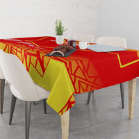 Flag-pattern tablecloth on dining table with red border and yellow-green geometric print