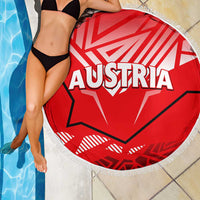 Red round Austria graphic beach blanket with white fringe edge, partly draped
