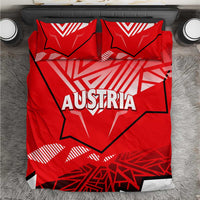 Red duvet cover and pillowcases with Austria text and geometric pattern