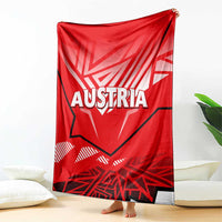 Red blanket draped with white AUSTRIA text and eagle emblem, gray border visible