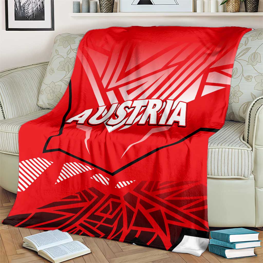 Red blanket with white eagle graphic and AUSTRIA lettering, gray-trimmed edge