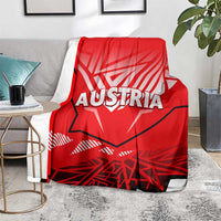 Red blanket with white AUSTRIA lettering and eagle graphic, gray underside trim