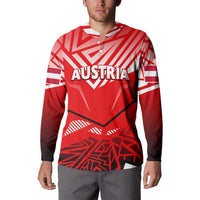 Red button sweatshirt with Austria text graphic, worn with gray pants, long sleeves