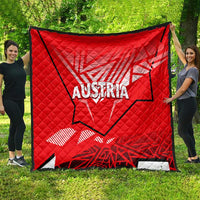 Red Austria quilt with quilted diamonds, black border, large Austria logo and emblem